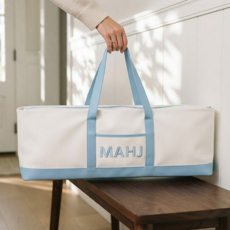 Hand carrying the long sky blue mahjong tote