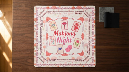 Four women test a mahjong mat's grip at a fellowship hall table, tiles and racks spread across it
