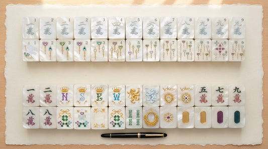 Four women in a library room compare a two-tone pastel mahjong tile against a solid-colored one