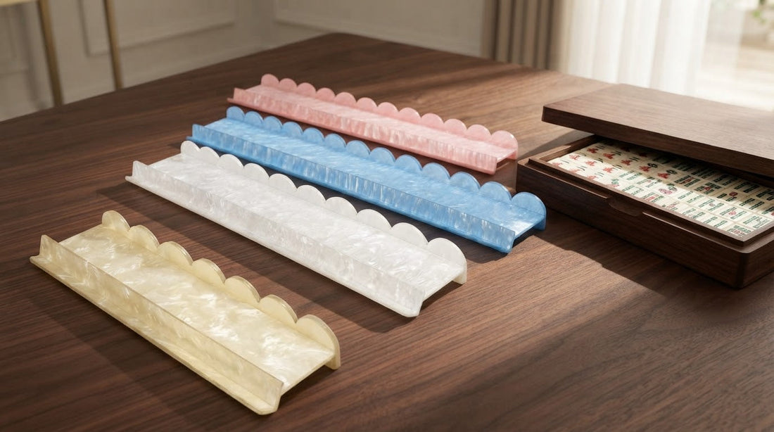 Four women in a club card room compare a smooth acrylic mahjong rack with an older wooden one