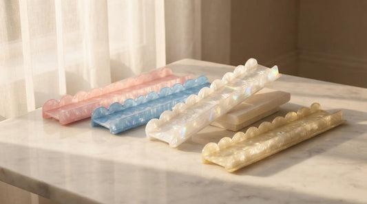 Four women at an art loft table with iridescent pearl shell mahjong racks and ivory tiles