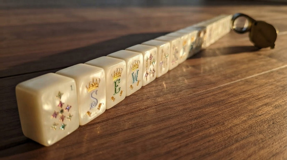 Four women examining the engraving on mahjong tiles in a sunlit church fellowship hall