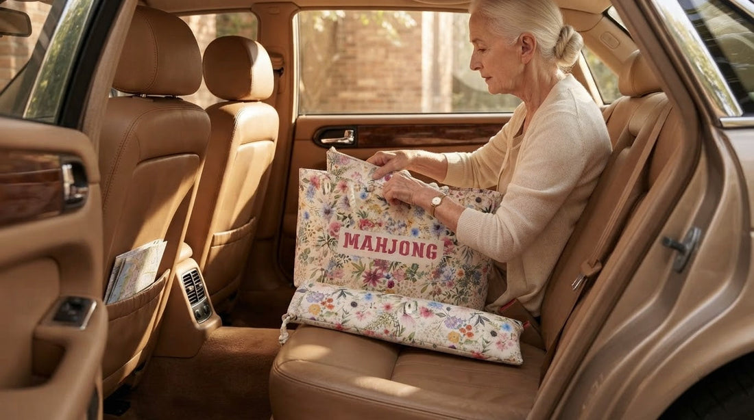 Four women setting up an impromptu patio mahjong game beside an open travel case