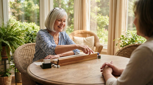 Four women at a church hall mahjong table on an autumn afternoon, coffee and cookies nearby