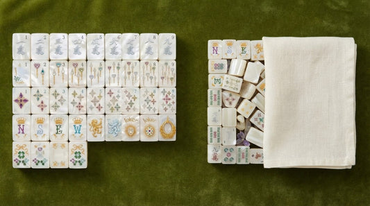 Four women at a condo clubhouse table, one pushing two matched sets into view