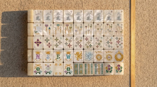 Four women at an assisted living activity room mahjong table on a spring afternoon