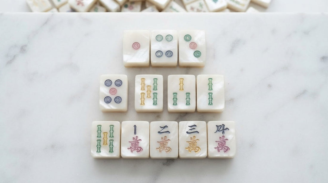 Women laughing at a church hall table as one lines up three matching tiles into a pung