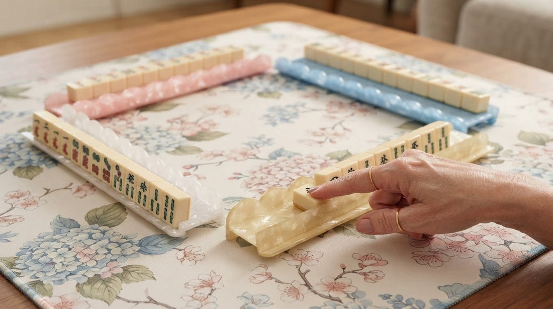 Player placing a tile face up on the mat at a hotel tournament table as another names it aloud