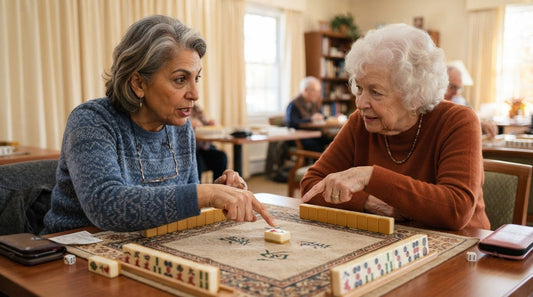Four women pausing play at a synagogue social hall mahjong table as one calls hold
