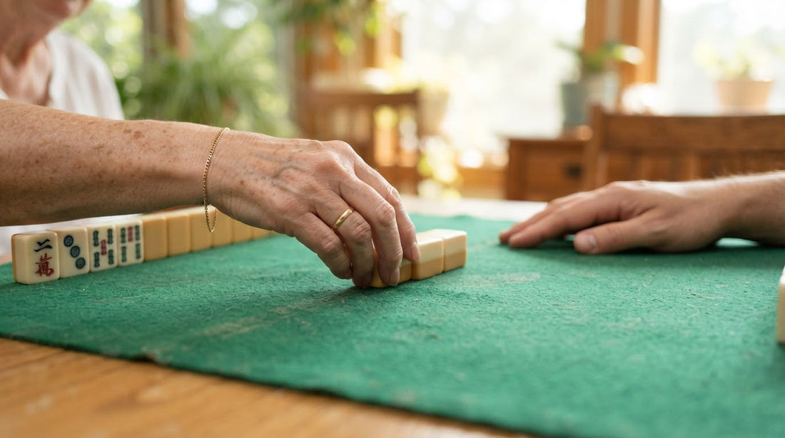 Three tiles slide across a community center table during the Charleston as four women watch the trade.