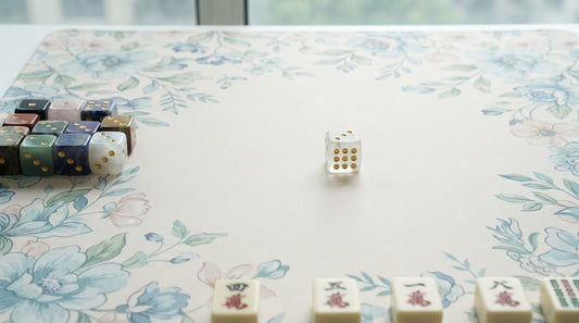 Four women passing a pair of gemstone dice at a beach house mahjong table by the ocean
