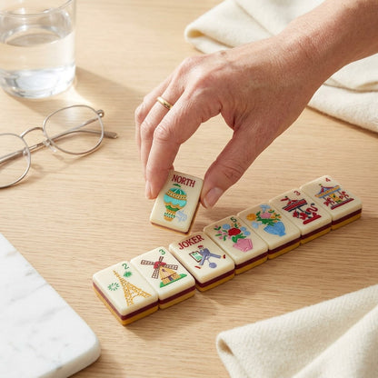 A hand setting a tile down