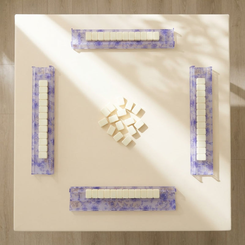 A mahjong table for four from above with a Blue Toile rack at each seat and tiles resting on every rack