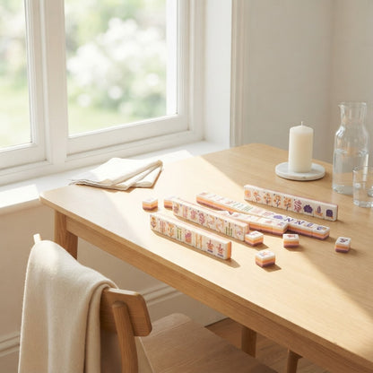 Blush Garden mahjong tiles on a sunroom table by the window