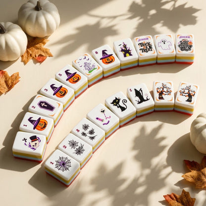Halloween mahjong tiles fanned in an arc, striped edges visible
