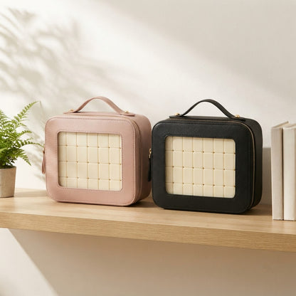 Pink and black Clear Window mahjong cases standing side by side on an oak shelf