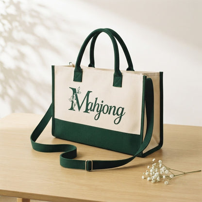 Canvas mahjong tote with green handles and an adjustable crossbody strap