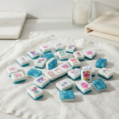 Flamingo Lagoon mahjong tiles scattered on a linen cloth