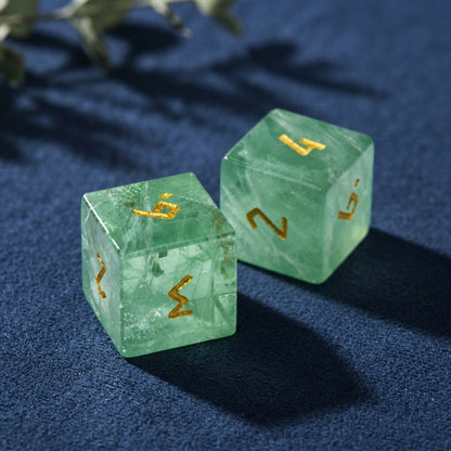 Close-up of two green fluorite dice showing natural veins