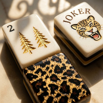 Macro of two tile faces beside a leopard-printed back