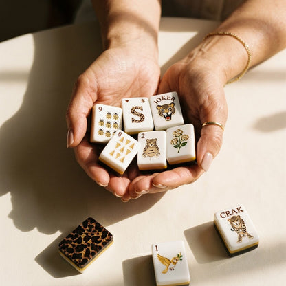 A handful of mahjong tiles cradled in a woman's hands