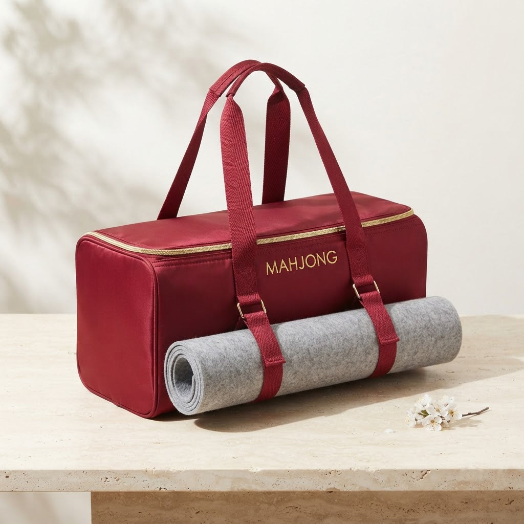 Red mahjong duffel with a rolled mat strapped to the front
