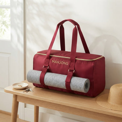 Red mahjong duffel on an entry bench by the front door