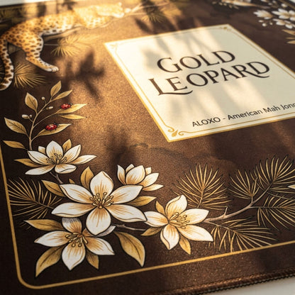 Close-up of the title panel and flowers on the Golden Leopard Grove mahjong mat