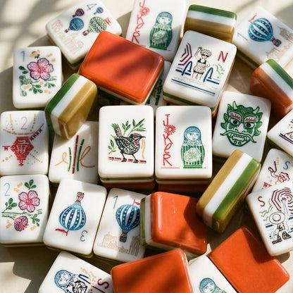 A loose pile of Grand Tour tiles shown close up, faces, edges and terracotta backs all visible at once