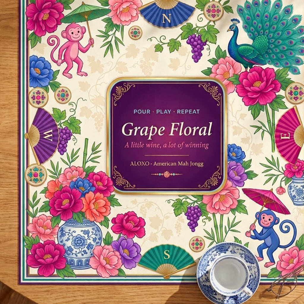 Grape & Peony Garden mahjong mat on a table with a teacup beside it for scale