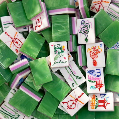 Close-up pile of Jade Marble tiles showing painted faces and green marbled backs