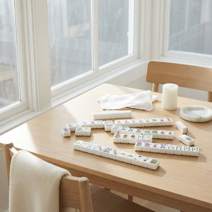 Ladies' Tee Time mahjong tiles on a sunroom table by the window