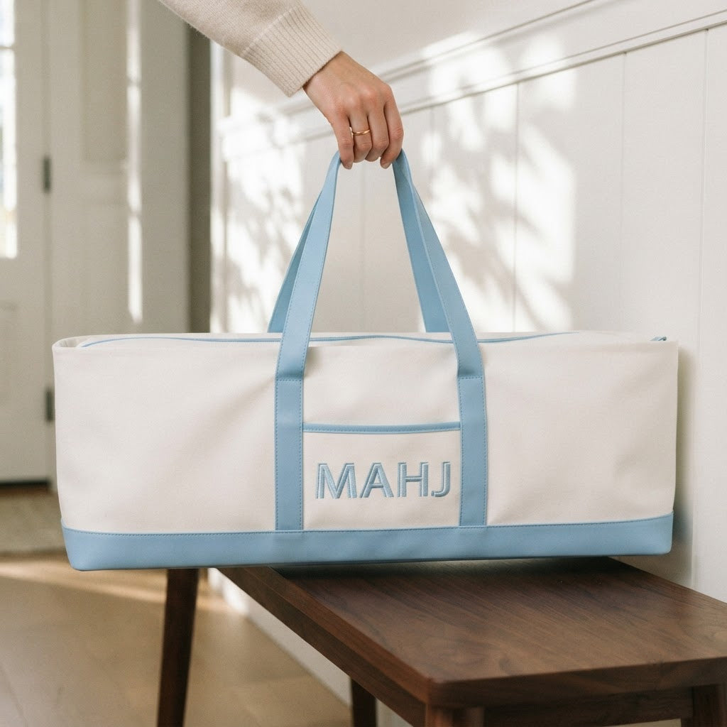 Hand carrying the long sky blue mahjong tote