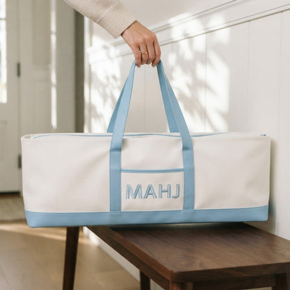 Hand carrying the long sky blue mahjong tote