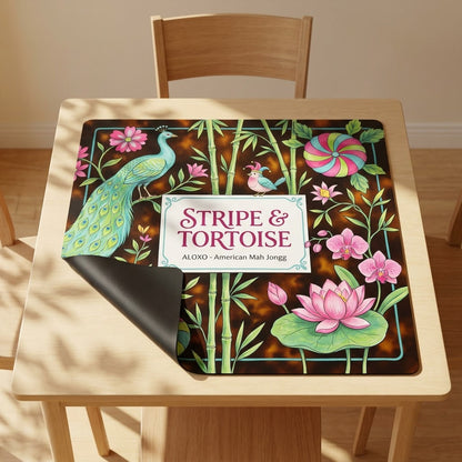Lotus Stripe & Tortoise mahjong mat with one corner folded back to show the black rubber underside