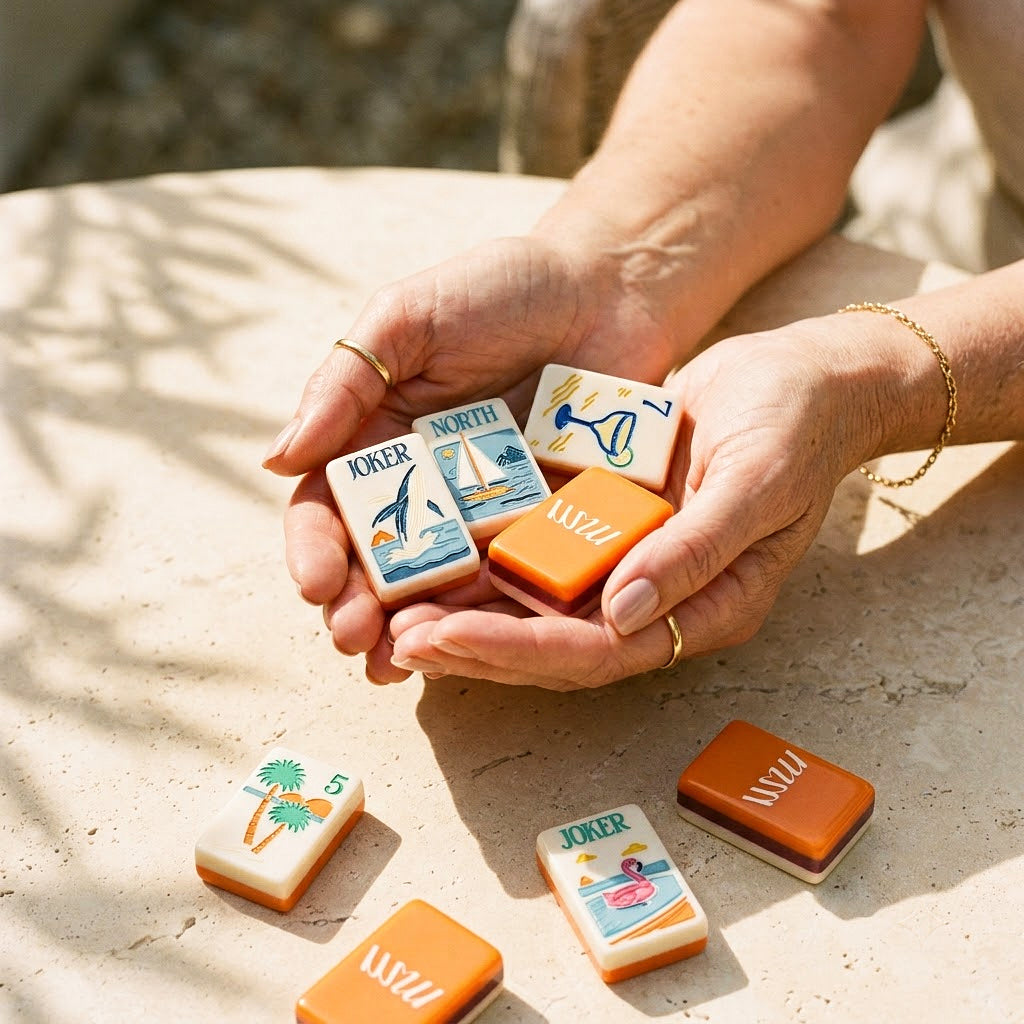 Womans hands cradling a handful of Margarita Coast mahjong tiles