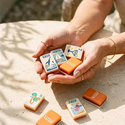 Womans hands cradling a handful of Margarita Coast mahjong tiles