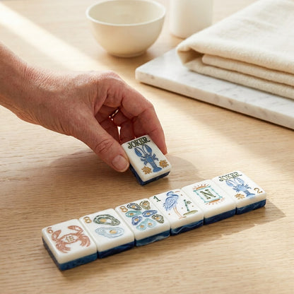 A hand setting a tile down