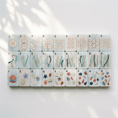 The three Nantucket Shore suits laid out one through nine with large Arabic numerals — sand dollars, seaweed and shells