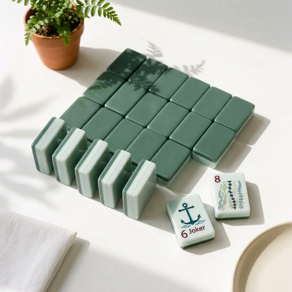 Deep sage green tile backs and the pale celadon edge profile of the Nantucket Shore mahjong tiles