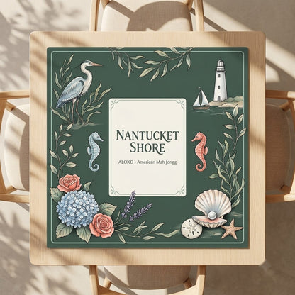 Nantucket Lighthouse Shore mahjong mat on a square card table with four chairs, seen from above