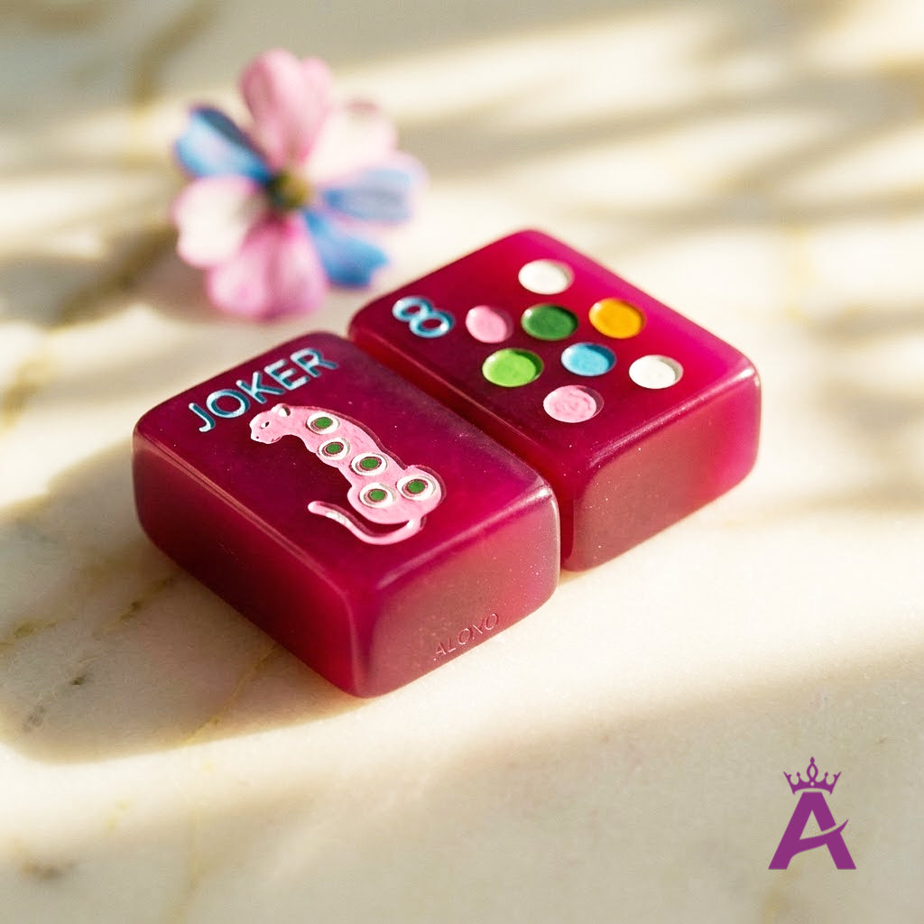 Macro close-up of engraved magenta mahjong Joker and dot tiles
