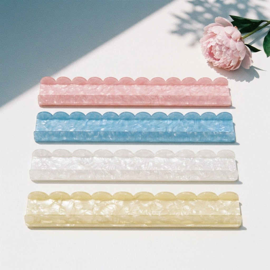Four Pearl Shell mahjong racks side by side from above in pink, sky blue, pearl white and butter yellow