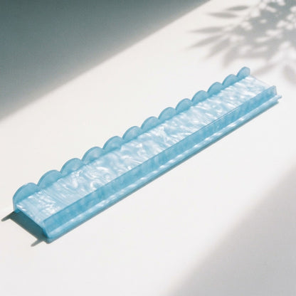 A single sky blue Pearl Shell mahjong rack showing the scalloped back, flat shelf and front ledge