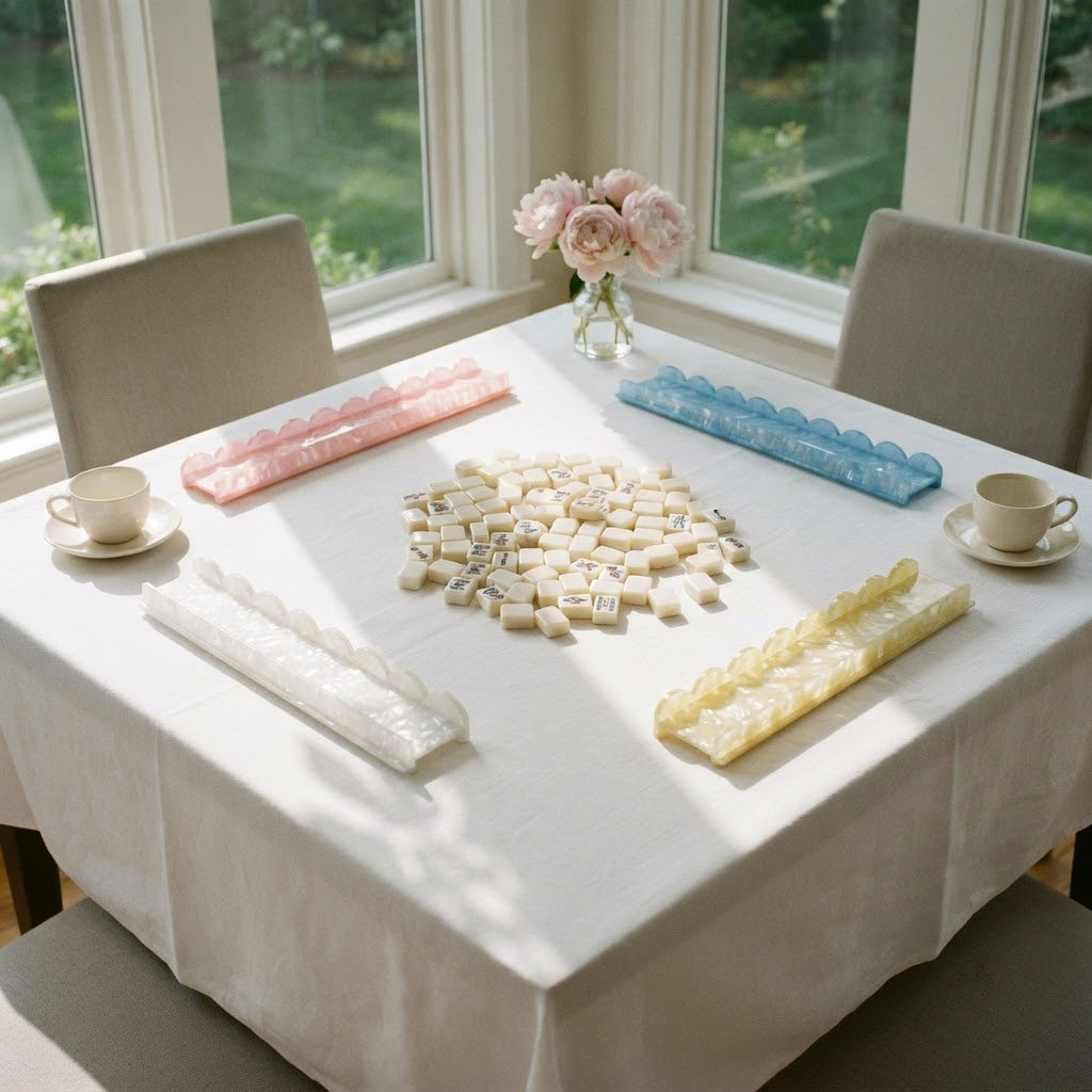 Four Pearl Shell mahjong racks set out for a game on a white tablecloth in a sunroom