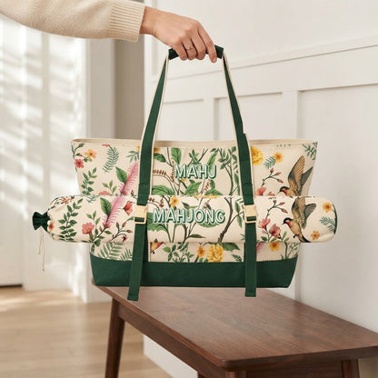 Hand carrying the Green Garden mahjong tote with the mat bag buckled on front