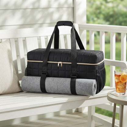 Black quilted mahjong duffel on a white porch bench
