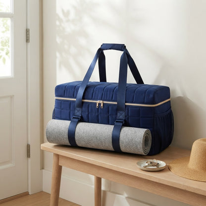Navy quilted duffel on an entry bench by the front door