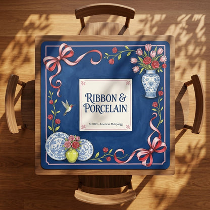 Rose Ribbon & Porcelain mahjong mat on a square card table with four chairs, seen from above