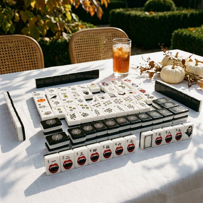 Gothic mahjong tiles on a linen table on a sunlit autumn terrace
